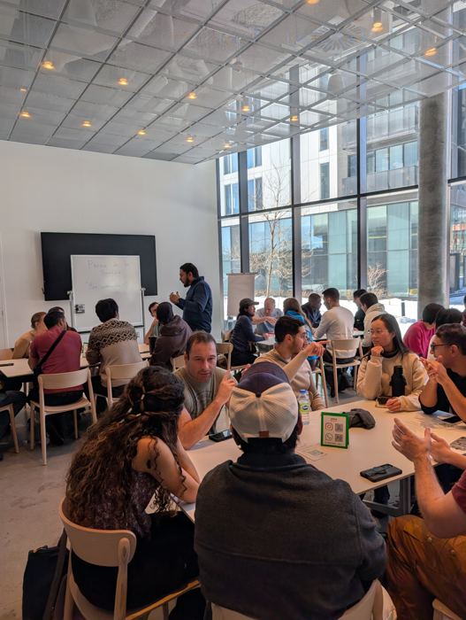 Abrar, co-founder of Pâtes et Parle, leading a French conversation session in Montréal